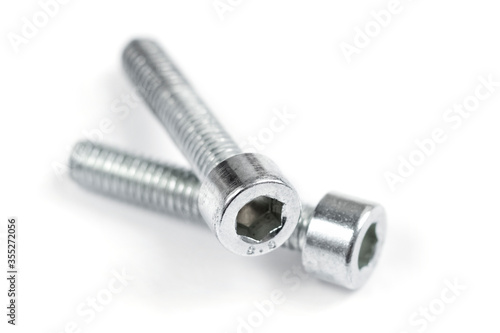 Two screw nuts on a white background. Stainless screws, bolts for construction