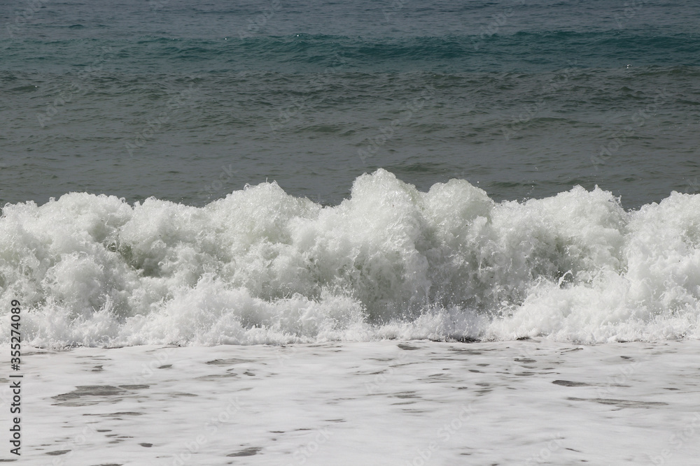 Fototapeta premium Splash of sea water after hitting a rocky cliff in southwestern Cyprus near the town of Paphos. Stormy and dangerous situation. Huge masses of water. Avalanche sea. Flood is coming