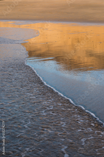 sea landscape. eflection at the sand beach photo