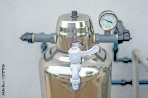 Bilde på lerret Subang Jaya, Selangor, Malaysia - December 27, 2019 : Outdoor master whole house stainless steel water purification filter system with stainless steel head and plastic tap