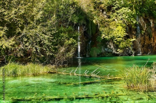 Landscape of waterfall and turquoise lake in the forest. Plitvice Lakes National Park. Nacionalni park Plitvicka Jezera  one of the oldest and largest national parks in Croatia. UNESCO World Heritage.