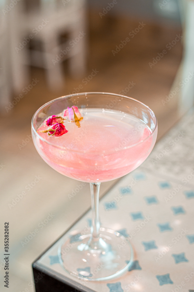 Pink Rose Sparkle Cocktail in the Bar, Blurred Background Pink Rose Sparkle Cocktail in the Bar, Blurred Background