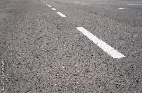 Wallpaper Mural Dark asphalt road with marking lines. Tarmac texture. White disabled sign on a empty parking lot. Black tarmac texture with road marking  Torontodigital.ca