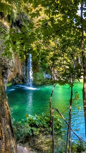 Landscape of waterfall and turquoise lake in the forest. Plitvice Lakes National Park. Nacionalni park Plitvicka Jezera, one of the oldest and largest national parks in Croatia. UNESCO World Heritage.