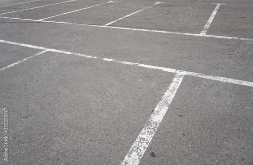 Wallpaper Mural Dark asphalt road with marking lines. Tarmac texture. White disabled sign on a empty parking lot. Black tarmac texture with road marking  Torontodigital.ca