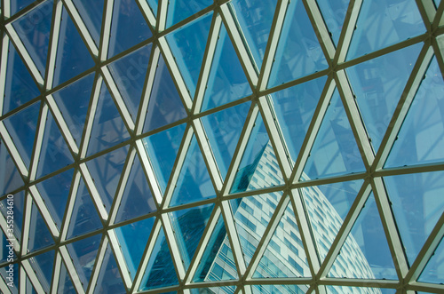 Glass windows grid on blue sky and building
