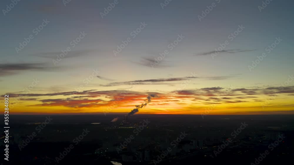 Power plant at sunset. Smoke from power plant chimneys illuminated by the setting sun.
Power plant at sunset. Smoke from power plant chimneys illuminated by the setting sun.