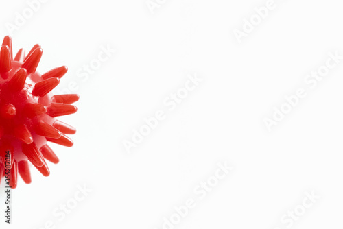 Red covid-19 virus in the form of a red ball with spikes and needles on a white background. Concept of health care and medicine during the period of quarantine and infection of people