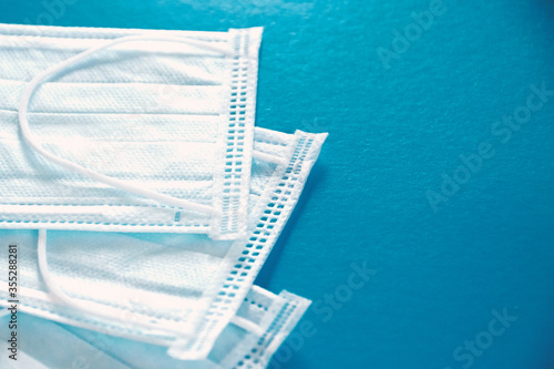 New protective blue medical face mask on a blue background. The concept of safety and prevention during an epidemic of viral infection COVID-19