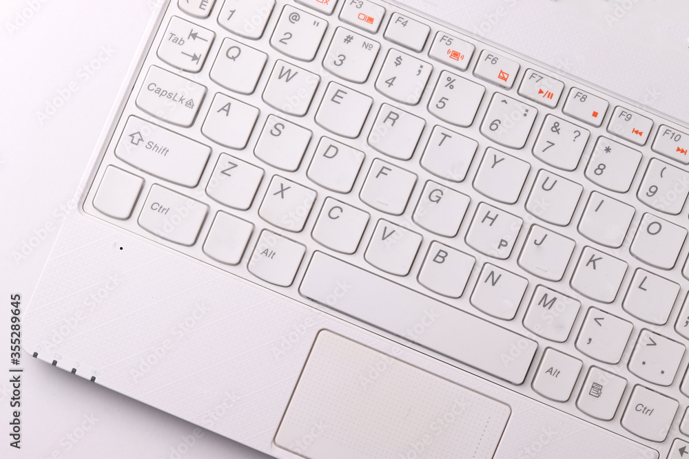 white laptop on the light background representing working environment white laptop on the light background representing working environment