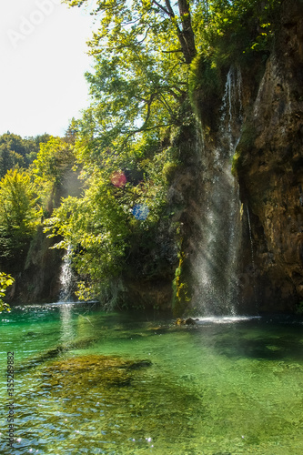 Landscape of waterfall and turquoise lake in the forest. Plitvice Lakes National Park. Nacionalni park Plitvicka Jezera, one of the oldest and largest national parks in Croatia. UNESCO World Heritage.
