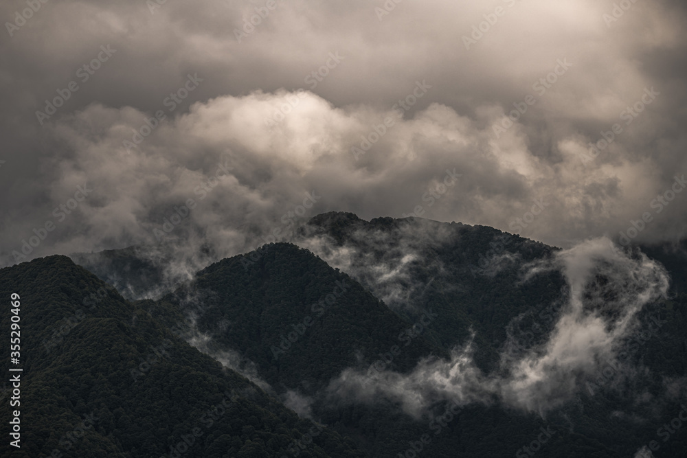 Fototapeta premium Mysterious black mountain with dramatic cloudy sky