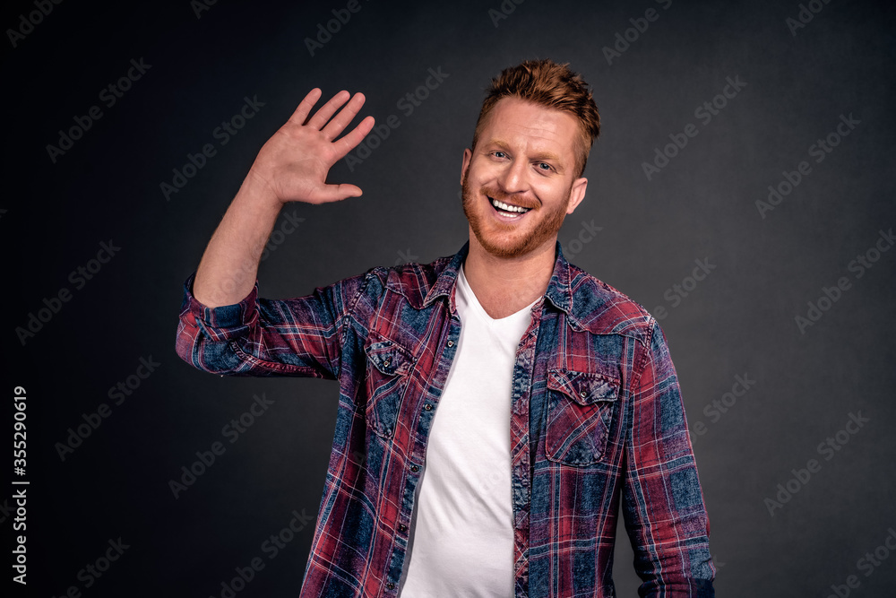 Handsome happy redhead man waiting for high five, smiling broadly raising palm high to greet person in modern way, welcoming close one over gray background, wearing trendy shirt Handsome happy redhead man waiting for high five, smiling broadly raising palm high to greet person in modern way, welcoming close one over gray background, wearing trendy shirt
