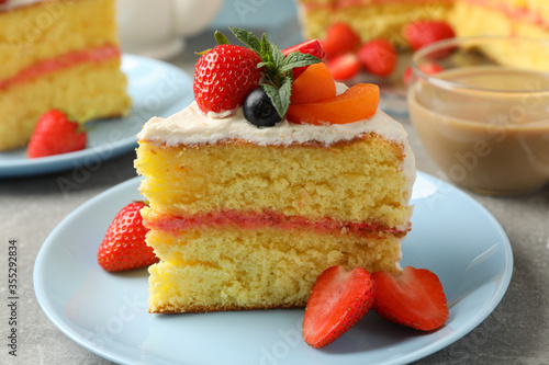 Composition with delicious berry cream cake on gray background. Tasty dessert
