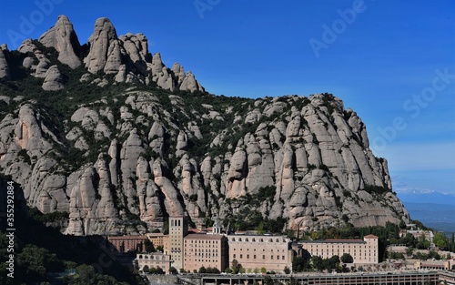 Monserrat Monastery in Spain seen from a trail in the mountains. 