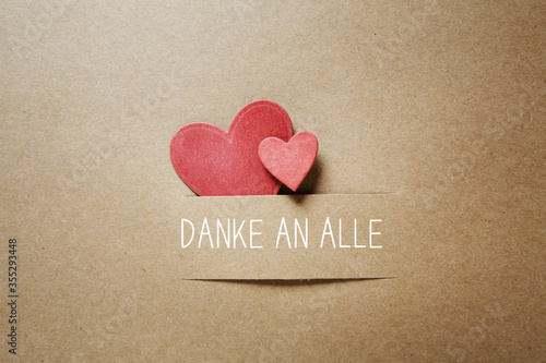 Danke an alle - Thank you all in German language with handmade small paper hearts