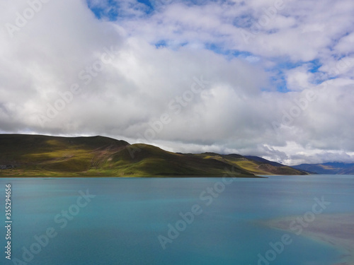 White clouds covers the mountain and lake in Tibet