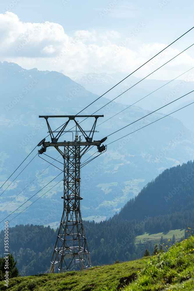 Cable car pylon on the side of Swiss Alps mountain