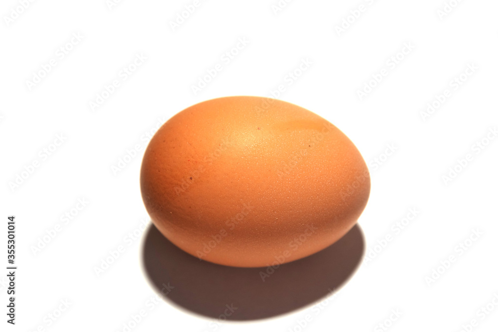 One brown egg on a white background. One brown egg on a white background.
