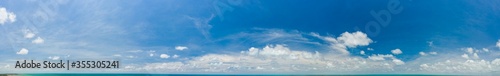 Beautiful sky panorama with slight ocean and land on bottom of frame