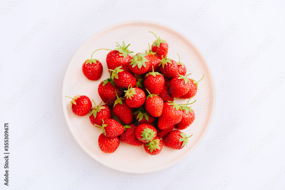 Fresh strawberries on the plate on a white background. Top view Fresh strawberries on the plate on a white background. Top view