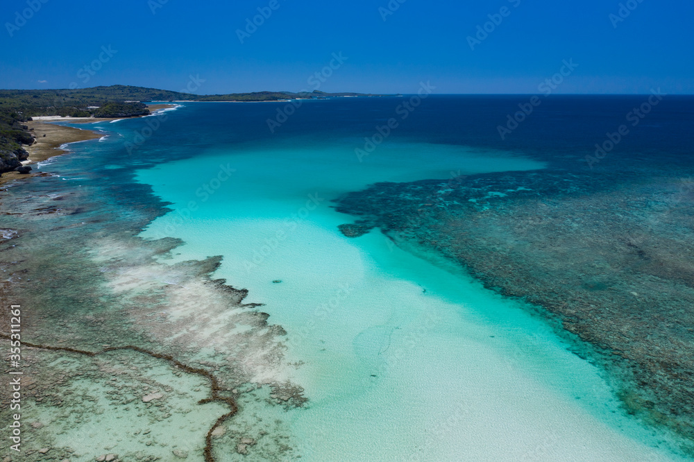 Obraz premium Aerial view taken by drone of a clear lagoon surrounded by coral reef in Rote island in the province of Timor in Indonesia.