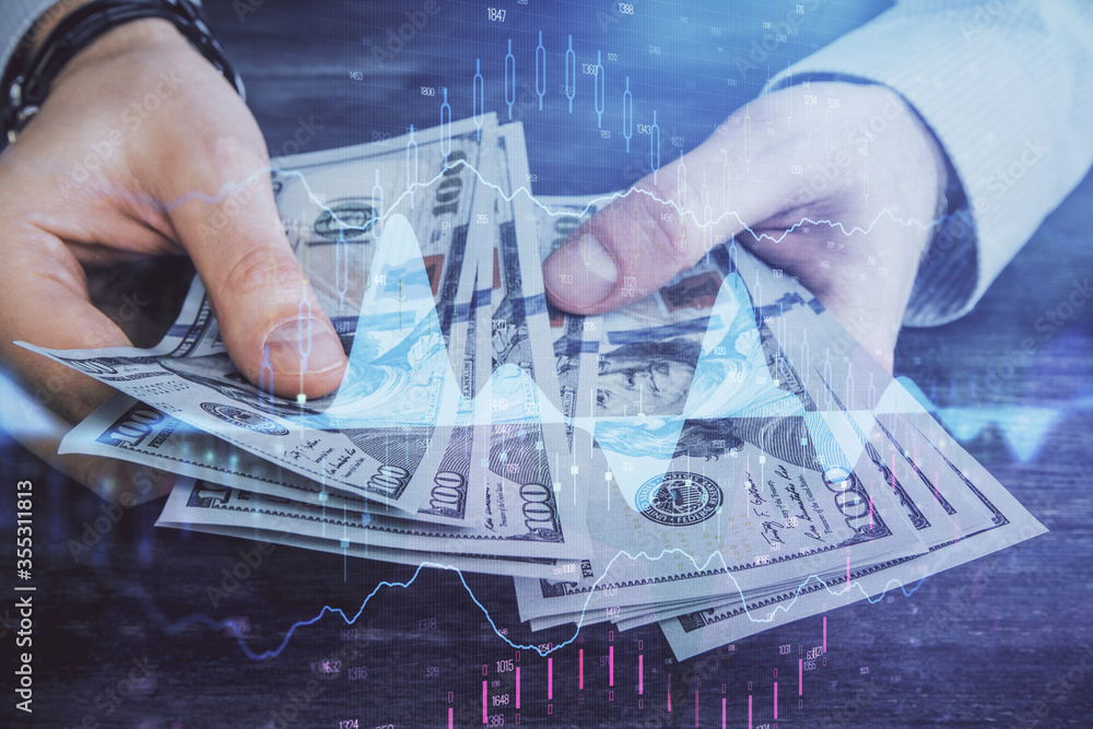 Multi exposure of financial graph drawing hologram and USA dollars bills and man hands. Analysis concept. Multi exposure of financial graph drawing hologram and USA dollars bills and man hands. Analysis concept.