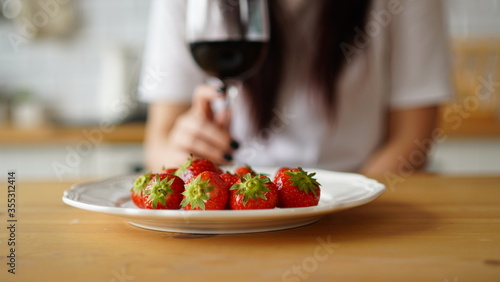 Wallpaper Mural Close up of glass of wine with strawberries on plate on table in kitchen. Concept of dating. Torontodigital.ca