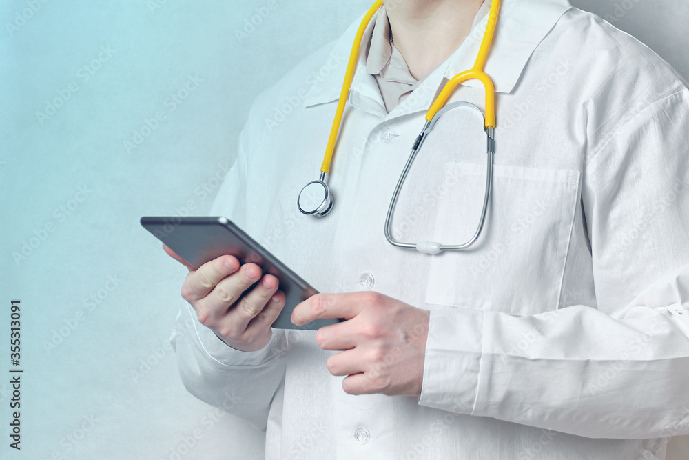 Doctor man holding a tablet with blue light. Doctor man holding a tablet with blue light.