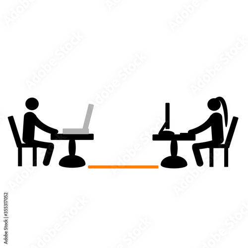 People work on computers. Social distancing. Keep a distance of 2 meters. Prevention of coronavirus. Covid-19. Be safe.