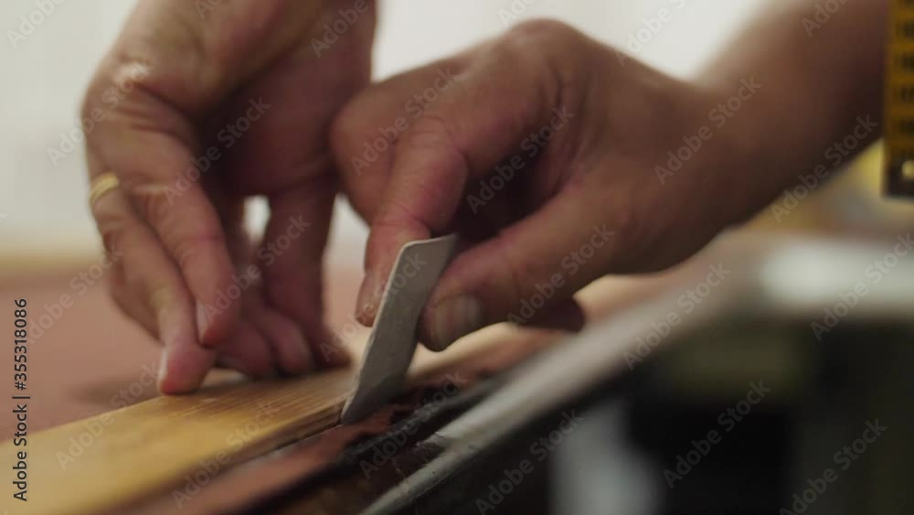 Tailor using chalk to mark a pattern in the fabric slow motion Tailor using chalk to mark a pattern in the fabric slow motion