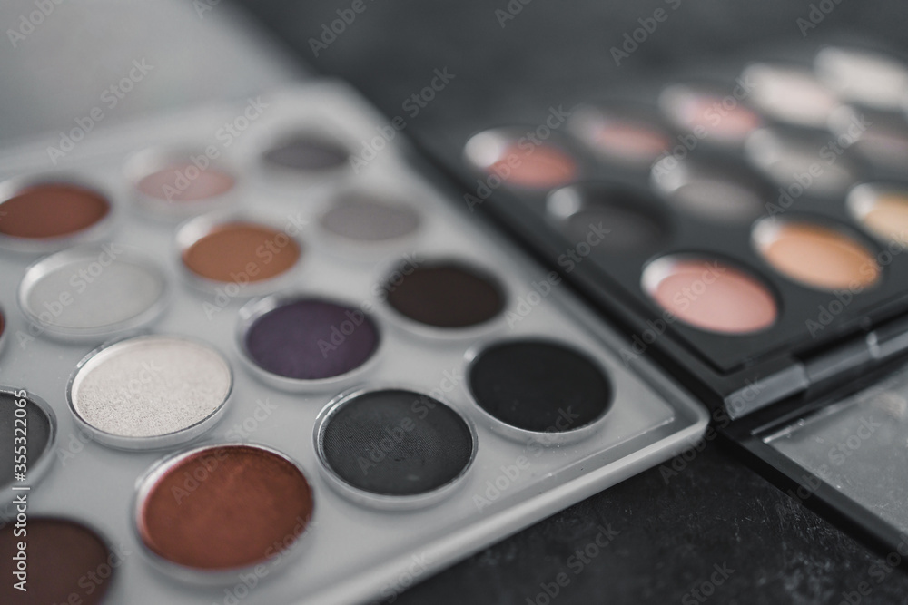 cosmetics and beauty, close-up of two similar eyeshadow palettes with neutral nude tones next to each other metaphor of competition cosmetics and beauty, close-up of two similar eyeshadow palettes with neutral nude tones next to each other metaphor of competition