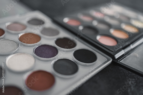 cosmetics and beauty, close-up of two similar eyeshadow palettes with neutral nude tones next to each other metaphor of competition