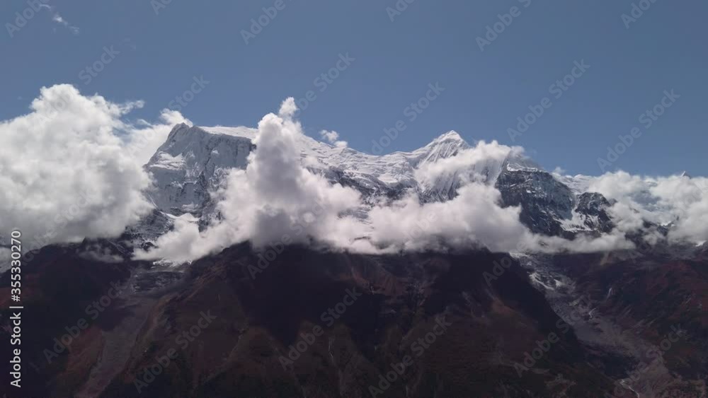 clouds running on blue sky over amazing white landscape of high rocky mountains and snowy valley himalaya nepal annapurna circuit clouds running on blue sky over amazing white landscape of high rocky mountains and snowy valley himalaya nepal annapurna circuit
