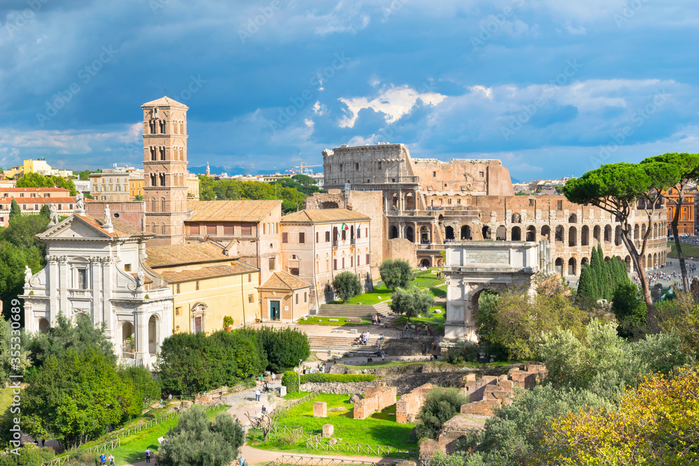 Beautiful view of Roman Forum ruins (Foro Romano) with Colosseum in the background - Rome, Italy