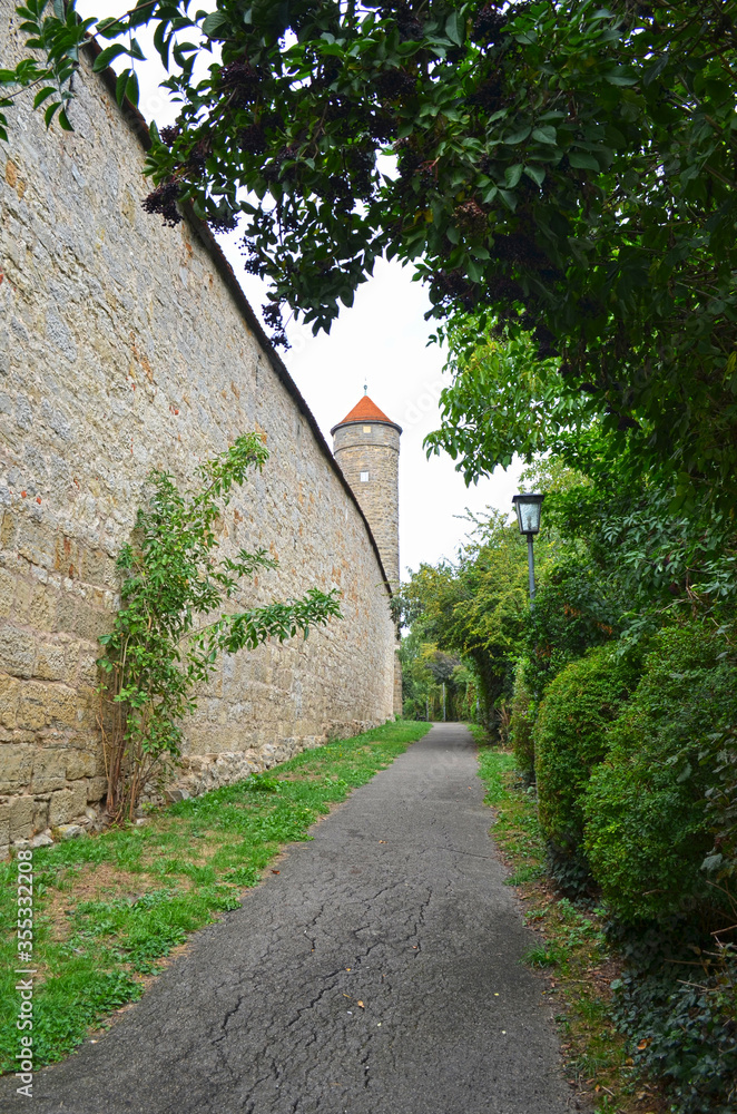 Beautiful street in Rothenburg, close of a brickstone wall and a medieval tower