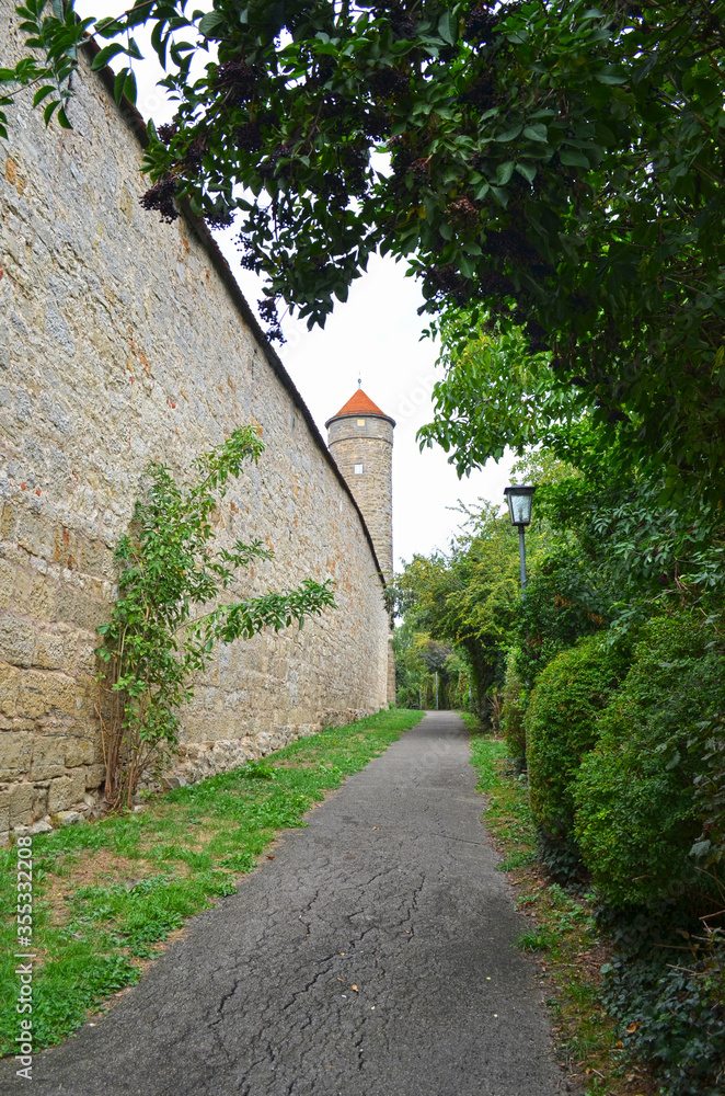 Beautiful street in Rothenburg, close of a brickstone wall and a medieval tower Beautiful street in Rothenburg, close of a brickstone wall and a medieval tower