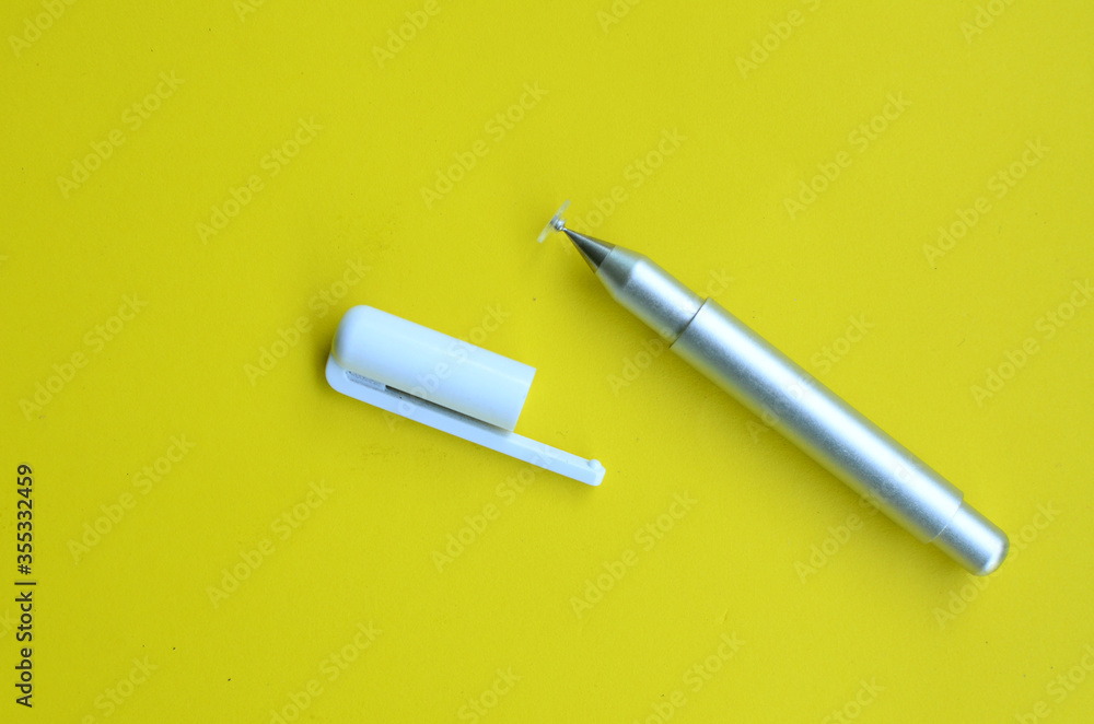 top view of the stylus pen on yellow background
top view of the stylus pen on yellow background