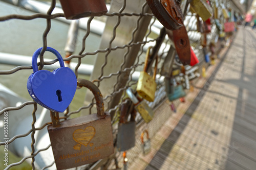 Love padlocks attached to the fence of Father Bernatek Footbridge in Krakow, Poland