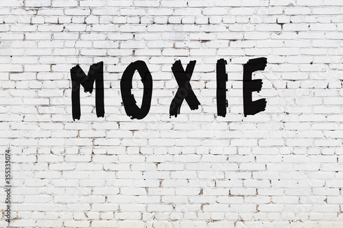 White wall with black paint inscription moxie on it