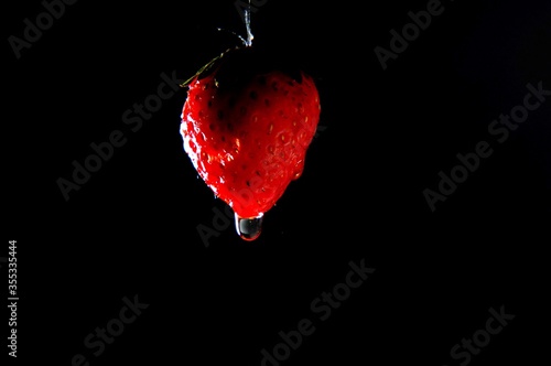 Red Strawberry hanging with water drop