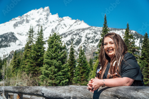 Woman nurse in black scrubs with a stethoscope in the mountains