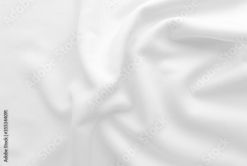 White abstract folded clothes background, fabric texture