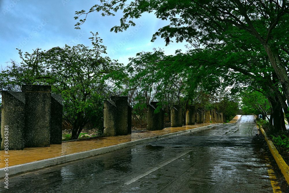 Abandoned concrete columns on rural road after a rainy day in Campeche Mexico