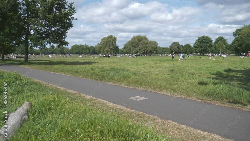 People resting in a park whilst maintaining the 'social distancing' rules. People resting in a park whilst maintaining the 'social distancing' rules.
