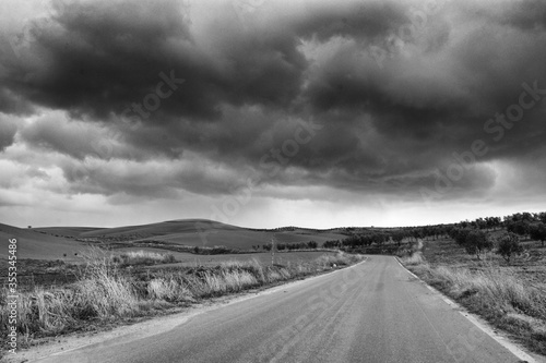 Lonely Art Nature Hills under cloudy sky stormy weather black and white image grainy effect