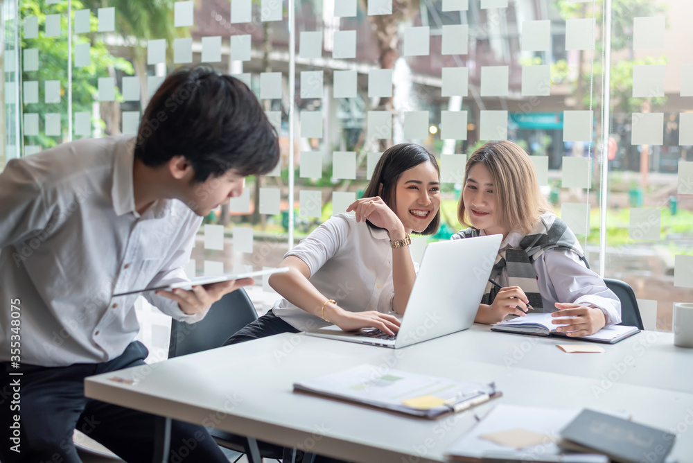 Young asian modern people in smart casual wear having meeting planning work together as a team and present ideas at work. Young asian modern people in smart casual wear having meeting planning work together as a team and present ideas at work.