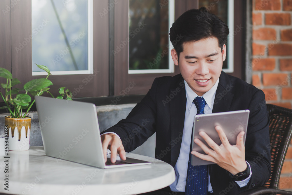 Handsome young businessman using digital tablet and computer outdoor. Handsome young businessman using digital tablet and computer outdoor.