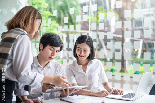 Young asian modern people in smart casual wear having meeting planning work together as a team and present ideas at work.