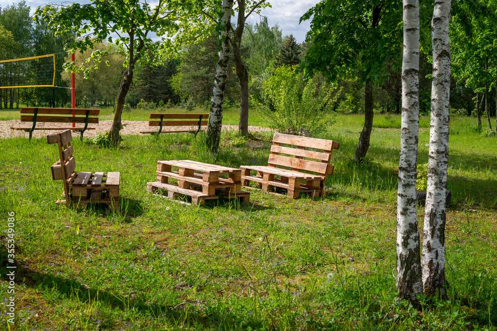 Rustic wooden table and benches at a lake Rustic wooden table and benches at a lake